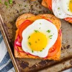 hummus toast layered with pickled red onions, tomatoes, and a fried egg - 18