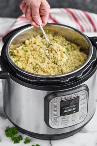 instant pot quinoa being dished out of an instant pot