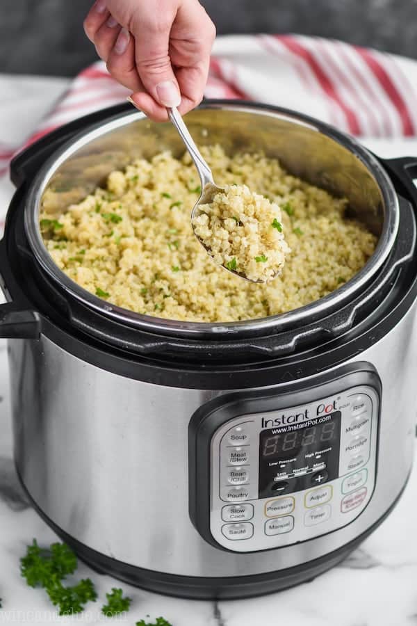 instant pot quinoa being dished out of an instant pot