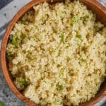 overhead view of quinoa that has been cooked in an instant pot in a small wooden bowl - 9