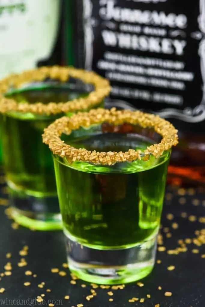 st patrick's day two shot glasses of lucky leprechaun shots rimmed with gold sprinkles 