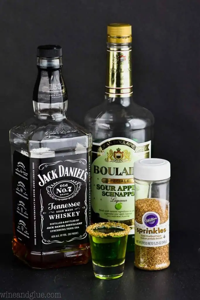 The ingredients of the Lucky Leprechaun shot which is Jack Daniel's Whiskey, Sour Apple Schnapps, and golden sprinkles. 