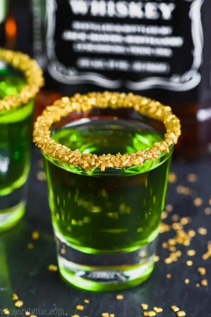 shot glass of lucky leprechaun shots rimmed with gold sprinkles