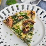 a piece of crustless spinach quiche on a white plate