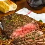 Pinterest graphic of front on picture of top round roast beef recipe sliced