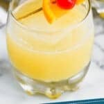 Pinterest graphic of a whiskey sour in a tumbler garnished with an orange and cherry