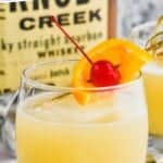 Pinterest graphic of whiskey sour recipe in a tumbler with an orange and a cherry