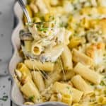 spoon dishing up marsala chicken noodle casserole from a baking dish