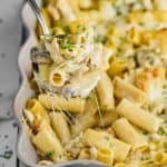 spoon dishing up marsala chicken noodle casserole from a baking dish - 7