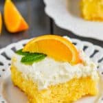 orange cake recipe on a plate garnished with a fresh orange