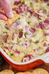 ritz cracker being dipped into reuben dip recipe