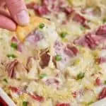 ritz cracker being dipped into reuben dip recipe