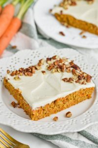 the best carrot cake recipe as a sheet cake on a white plate