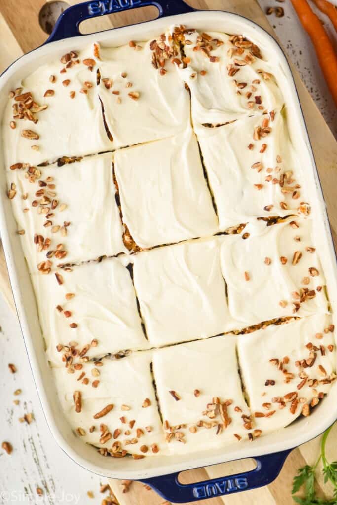 overhead photo of a 9 by 13 pan with carrot cake cut into squares