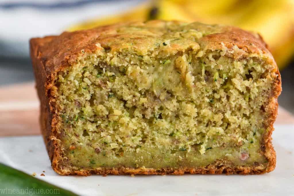 loaf of zucchini banana bread cut in half, showing the inside of the bread close up