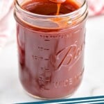 pinterest graphic spoon dipping into a mason jar full of easy homemade bbq sauce, says: the best bbq sauce simplejoy.com