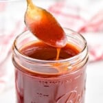 pinterest of spoon dipping into a mason jar full of easy homemade bbq sauce, says: the best bbq sauce recipe, simplejoy.com