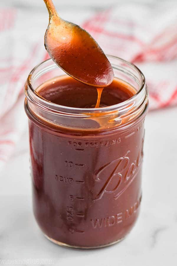 spoon dipping into a mason jar full of easy homemade bbq sauce