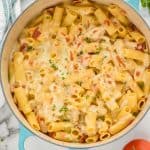 overhead view of chicken bacon ranch pasta bake with broiled mozzarella and rigatoni in a teal dutch oven