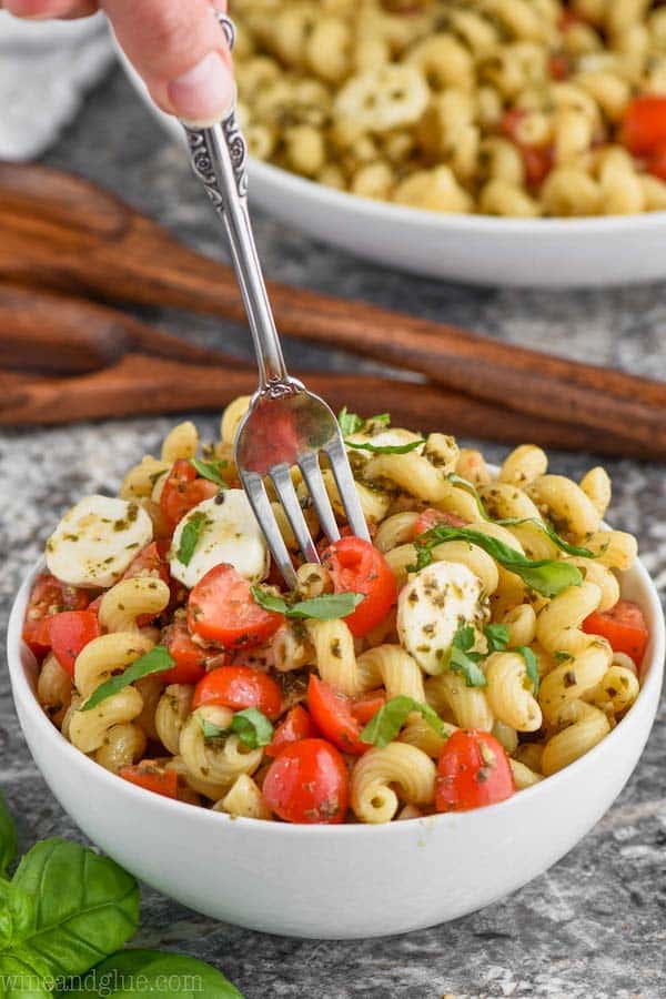 bowl of pesto pasta salad with fork coming out