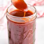 spoon dipping into a mason jar full of easy homemade bbq sauce - 19