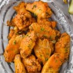 crockpot chicken wings in wax paper and a wire basket