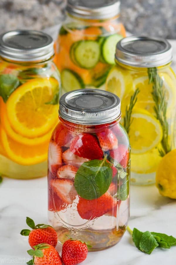four mason jars filled with infused water