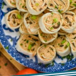 Pinterest graphic of an overhead of a plate of pinwheels recipes, says: "taco pinwheels simplejoy.com"