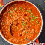 overhead view of a red stock pot with a vegetarian chili recipe and a metal ladle coming out of it - 9