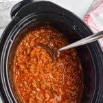 pinterest graphic of overhead of a slow cooker full of sloppy Joe mix, says: "slow cooker sloppy joes simplejoy.com"