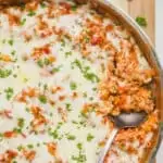 overhead of a skillet of stuffed pepper casserole with a spoon digging in