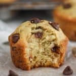 a close up of a banana chocolate chip muffin with a bite mixing