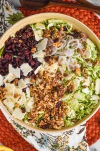 overhead view of brussel sprout salad divided by ingredients