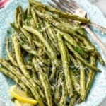 side view of a platter full of roasted green beans