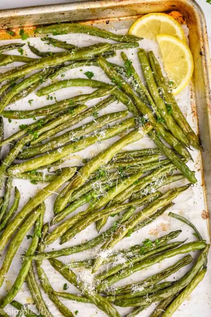 overhead view of a baking sheet full of roast green beans