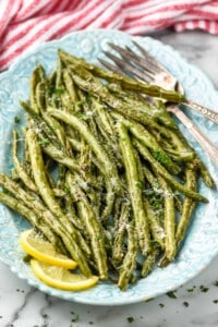 side view of a platter full of roasted green beans