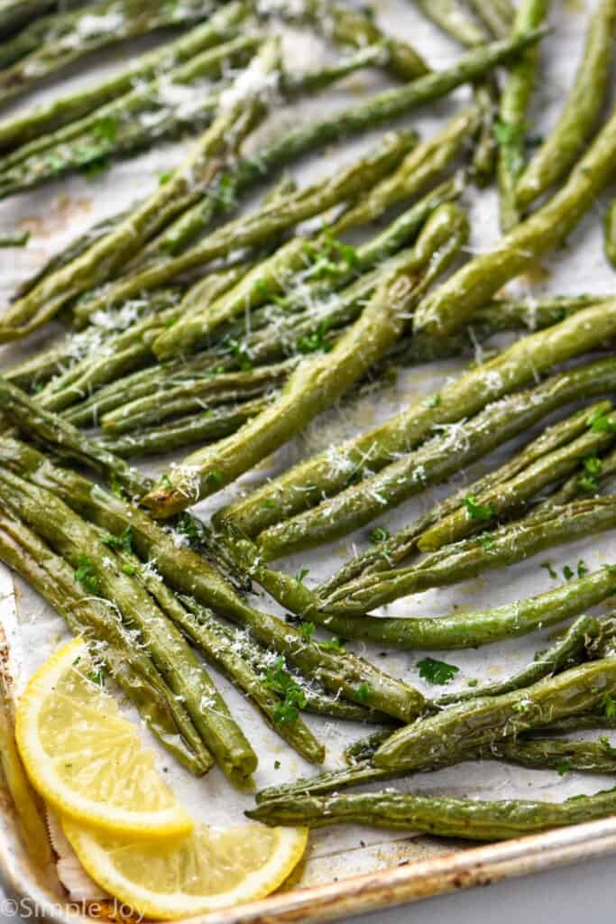 side view of a pan a baking sheet full of oven roasted green beans