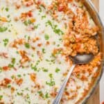 overhead of a skillet of stuffed pepper casserole with a spoon digging in - 15