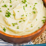 Pinterest graphic of instant pot mashed potatoes in a wooden bowl with parsley garnish and a square of butter on top, says: instant pot mashed potatoes simplejoy.com
