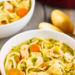pinterest graphic of close up of a white bowl full of turkey noodle soup recipe with slices of carrot, pieces of turkey, and long egg noodles visible, says: the best turkey soup simplejoy.com