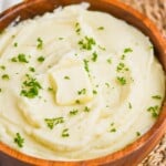 instant pot mashed potatoes in a wooden bowl with parsley garnish and a square of butter on top - 13