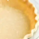 close up side view of a pie crust in a pan