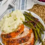 plate with turkey breast recipe, mashed potatoes, and green beans