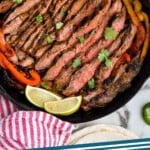 Pinterest graphic of Steak Fajitas recipe. Image is overhead photo of Steak Fajitas in a cast iron skillet. Text says, "Steak Fajitas simplejoy.com"