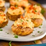 pinterest graphic of stuffed mushroom caps on a platter with wine in the background