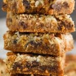 an up close picture of a stack of magic bars with a bite missing from the top one