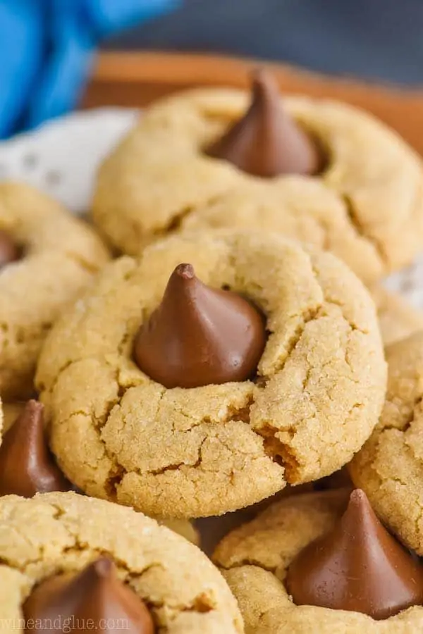 a close up photo of a peanut butter blossom - crisp peanut butter cookie with a Hershey kiss buried into the top
