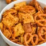 up close of a white bowl full of ranch chex mix