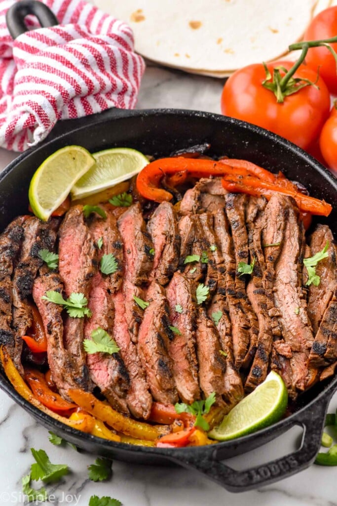 Overhead photo of Steak Fajitas in a cast iron skillet.