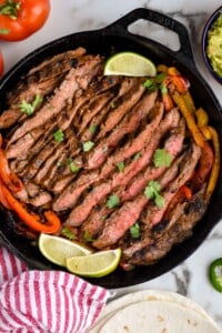 Overhead photo of Steak Fajitas in a cast iron skillet.